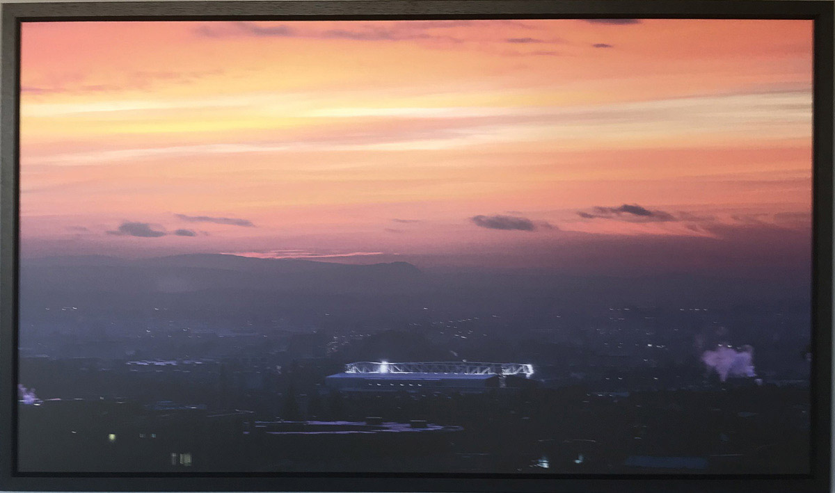 Photo of Tynecastle at dusk with orange sky